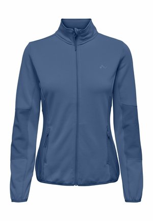 Blå glidelåsjakke for kvinner med høy krage, ribbestrikkede paneler på ermer og sider, og glidelåslommer på sidene.