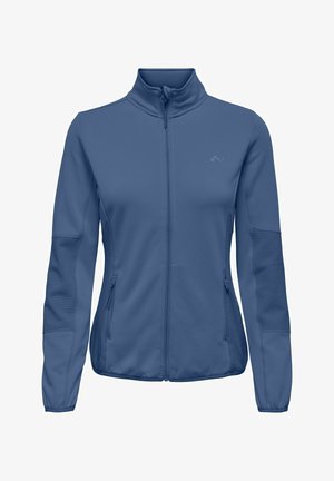 Kék cipzáras női dzseki magas nyakkal, bordázott panel részletekkel az ujjakon és az oldalakon, valamint cipzáras oldalzsebekkel.