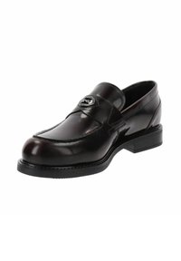 Mocassino in pelle marrone con punta rotonda, dettagli cuciti e un emblema d'argento su una fascia lungo la parte superiore. Suola in gomma nera.