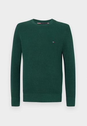 Grønn strikket crewneck genser med lange ermer, med en liten logo på brystet og ribbede mansjetter og hem. Strukturert stoff.