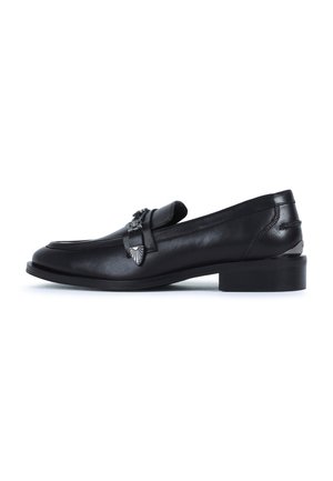 Black leather loafers with a sleek, rounded toe and low block heel. Features decorative metallic hardware on the vamp. Smooth texture.