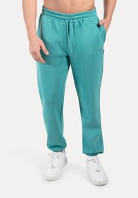 Turkooize sweatpants van een katoenmix, met een elastische tailleband met trekkoord, zijzakken en een comfortabele pasvorm.