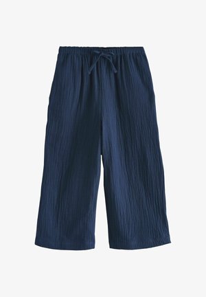 Tengerészkék, széles szárú, rövidített nadrág texturált anyagból, rugalmas derékrésszel és elöl megkötős zsinórral.