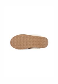Shoe sål med en tekstureret gummioverflade i lys brun, med et bølget mønster til greb og en fluffy hvid øverste kant.