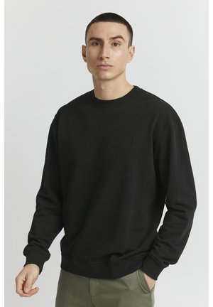 Black sweatshirt with round neckline, ribbed cuffs, and hem. Features a subtle logo on the chest. Made from a soft fabric.
