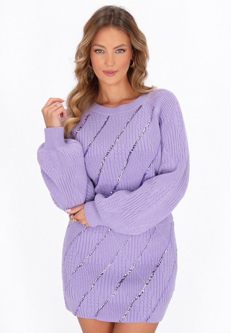 Abito maglione viola con motivi a trecce e file diagonali di paillettes. Maniche lunghe e voluminosi con polsini a costine.