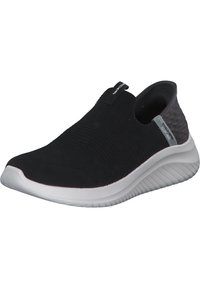 Sneaker nera senza lacci con tomaia in maglia testurizzata, suola intermedia bianca imbottita e sottili accenti grigi nel tallone e nel marchio.