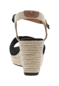 Wedge sandal with beige braided rope heel, black fabric upper, and beige ankle strap with buckle and brown leather detail.