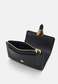 Black leather wallet with gold zipper and hardware, featuring a textured surface. Open with a main compartment and a front snap closure.