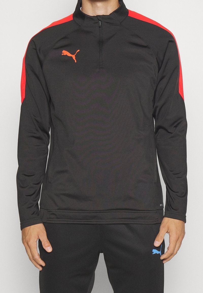 Schwarzer Sportpullover mit roten Schulterpaneelen, Viertel-Reißverschluss-Kragen und orangefarbenem Puma-Logo. Hergestellt aus glattem, leichtem Material.