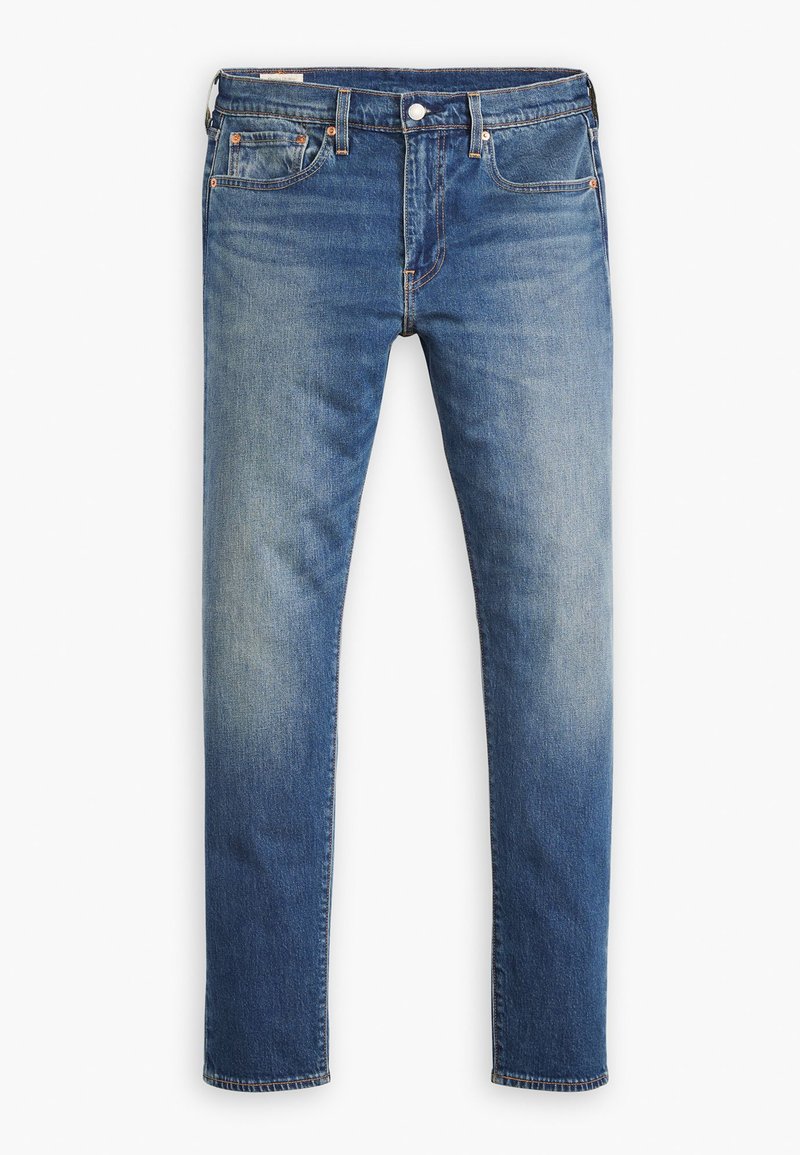 Smala jeans i medelblå denim, med blekta områden, femfickorsdesign, metallknappstängning och synliga sömnadsdetaljer.