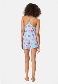 Light blue pajama set with strawberry pattern, featuring a sleeveless top and shorts. Soft fabric, relaxed fit, with thin straps and a playful design.