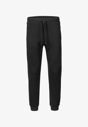 Black tapered sweatpants with elastic waistband, drawstring closure, side pockets, and ribbed ankle cuffs.