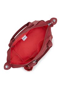 Red fabric bag featuring a zip closure, double handles, and a bright red interior. Includes a small inner pocket and logo tag.