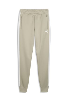 Beżowe spodnie dresowe Puma z elastycznym pasem, kieszeniami bocznymi na zamek, białymi paskami na nogawkach oraz logo Puma na górnej lewej uda.
