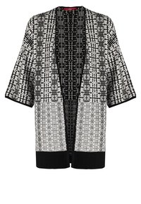Cardigan noir et blanc à motif, avec un devant ouvert, des manches courtes et un ourlet côtelé. Présente des motifs géométriques et une coupe lâche et décontractée.