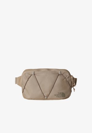 Tan fabric waist bag with grid pattern, zippered top, elastic cord detail on front, and logo printed on lower right corner.