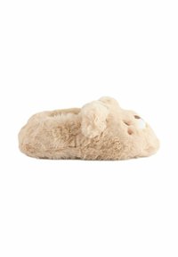Chausson en forme de lapin en peluche beige, avec une texture de fourrure douce, un nez arrondi et de petites oreilles, doté d'une semelle plate et solide pour un usage intérieur.