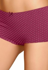 Burgundské nohavičky vyrobené z jemného materiálu, s decentným kvetinovým vzorom a mašľou na páse. Hladký povrch, stredne vysoký strih.