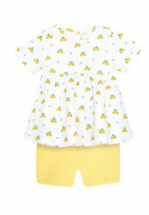 Robe bébé blanche à manches courtes avec imprimé citron jaune, associée à un short jaune uni.