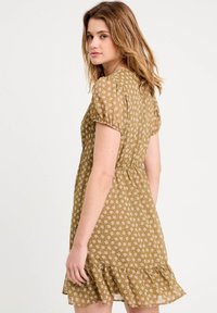 Vestito marrone floreale con maniche a palloncino corte, orlo arricciato, tessuto testurizzato e vita elastica per un fit rilassato.