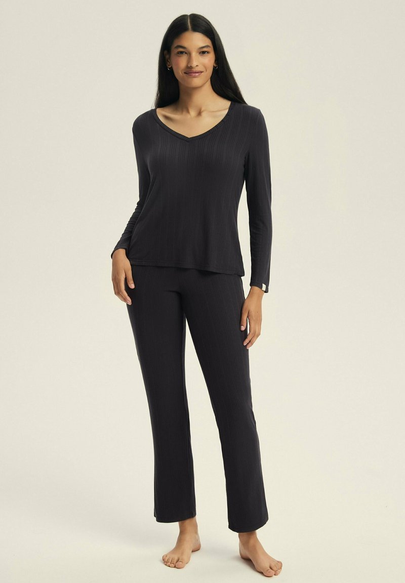 Dark gray ribbed pajama set with long sleeves, v-neckline, and straight-leg pants, featuring a soft texture and minimalistic design.