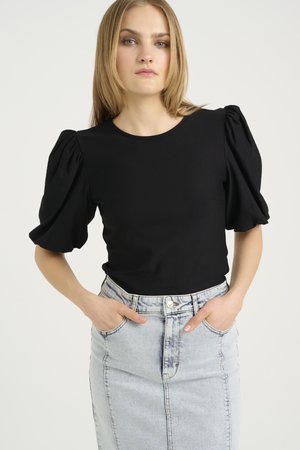 Black puff-sleeve top with a round neckline, paired with a light blue denim pencil skirt featuring front pockets and a button closure.
