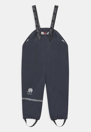 Waterproof navy overalls made of smooth material, featuring adjustable suspenders and reflective stripe. Includes a small elephant logo.
