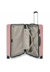 Valigia rigida rosa con interni beige, dotata di cinghie incrociate, tasca con zip e manico telescopico. Include quattro ruote.