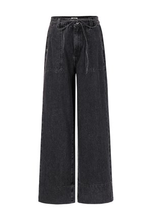 High-waist black wide-leg jeans with large front patch pockets and a thin tied belt at the waist.
