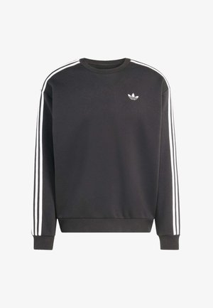 Čierna mikina z mäkkej látky, s bielymi pruhmi pozdĺž ramien a malým bielym logom na prsiach. Klasický dizajn s okrúhlym výstrihom.