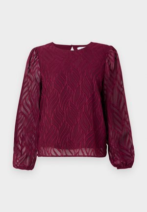 Burgundy blus med genomskinliga långärmar, med ett bladmönster i broderad detalj och en rund halsringning med en nyckelhålsstängning bak.