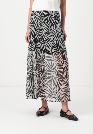 Black and white leaf-patterned skirt made of sheer material, featuring a drawstring waist and two side slits, layered over a solid underlayer.