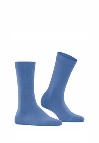 Chaussettes en coton bleu clair présentant un poignet côtelé, une texture lisse et une longueur standard avec un talon et un orteil renforcés.