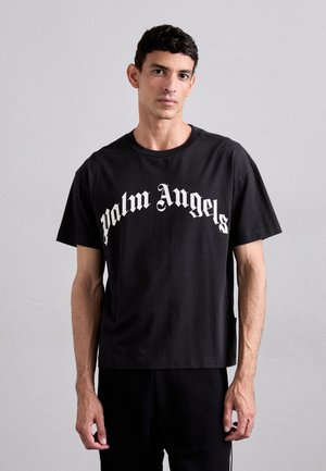 Melnas kokvilnas t-krekls ar "Palm Angels" logo baltā krāsā, ar brīvu piegriezumu un apaļu kakla izgriezumu. Gluda tekstūra un īsās piedurknes.