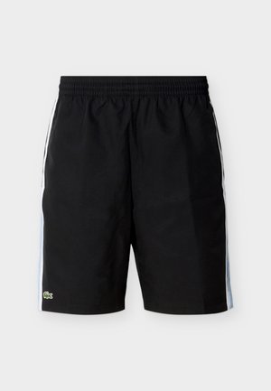 Črne športne hlače s širokim elastičnim pasom, belimi in svetlo modrimi stranskimi črtami ter majhnim zelenim logotipom krokodila na spodnjem robu leve noge.