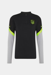 Schwarzes sportliches Langarm-Top mit halbhohem Reißverschluss, neon-grünen Akzenten an den Schultern und grau gemusterten Ärmeln. Mit einem Logo auf der Brust.