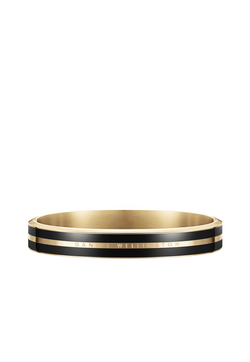 Kullatud ja musta värvi bangle-käevõru läikiva viimistlusega, millel on kitsas must triip ja graveeritud "DANIEL WELLINGTON" aksent.