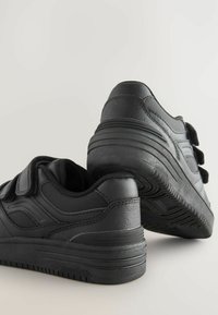 Scarpe sportive nere in materiali di pelle e rete, con una forma arrotondata, doppie cinghie in Velcro e suole in gomma testurizzata.
