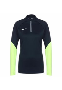 Top sportivo a maniche lunghe di colore blu scuro con maniche verdi neon. Presenta un colletto alto e una chiusura a zip quarti. Realizzato in tessuto leggero e elasticizzato.