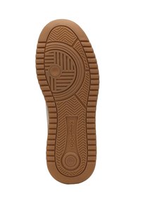 Tan rubber sole with a textured pattern, featuring circular and horizontal grooves, and embossed "KangaROOS" logo.