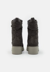 Gray suede ankle boots with a textured surface, ribbed rubber soles, and zip closures on both sides, featuring a soft lined collar.