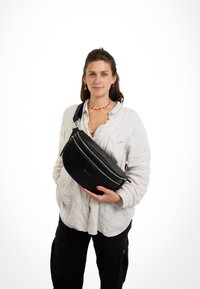 Black leather sling bag with a rounded shape, double zippers, and a sturdy strap. Smooth texture with subtle logo detail on front.