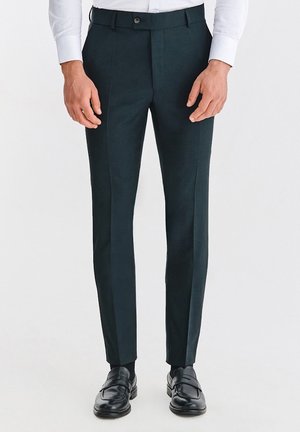 - Spodnie materiałowe