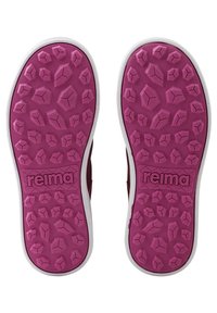 Semelles de chaussures en caoutchouc rose avec un motif de griptexturé, comportant des formes géométriques en relief et une bordure blanche. Logo "Reima" affiché en évidence.