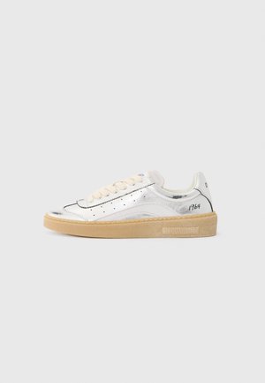 Silver sneaker with a shiny finish, beige laces, perforated detailing, and a rubber sole. Features branding on the heel and side.