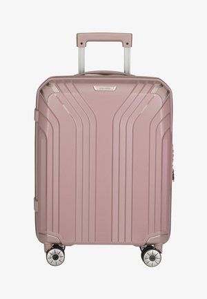 Pink hard-shell suitcase with vertical grooves, telescoping handle, and four spinner wheels. Features silver accents and zipper closure.