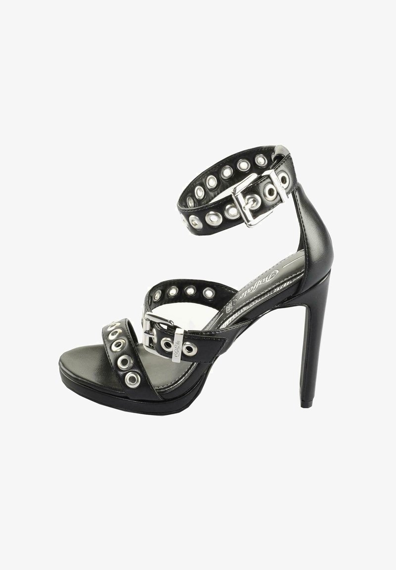 Melnas augstpapēžu čības ar platām potīšu siksnām, sudraba kniedēm un sprādžu akcentiem. Gluda ādas virsma ar atvērtu purngalu.