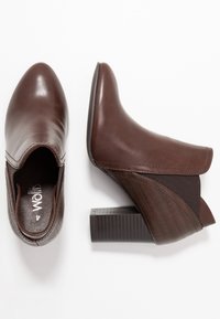 Botas de tobillo de imitación cuero marrón con puntera afilada, panel lateral texturizado, inserto elástico y tacón grueso.