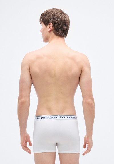 White cotton boxer briefs with a navy blue waistband featuring "POLO RALPH LAUREN" branding. Smooth texture, fitted design, and mid-rise cut.